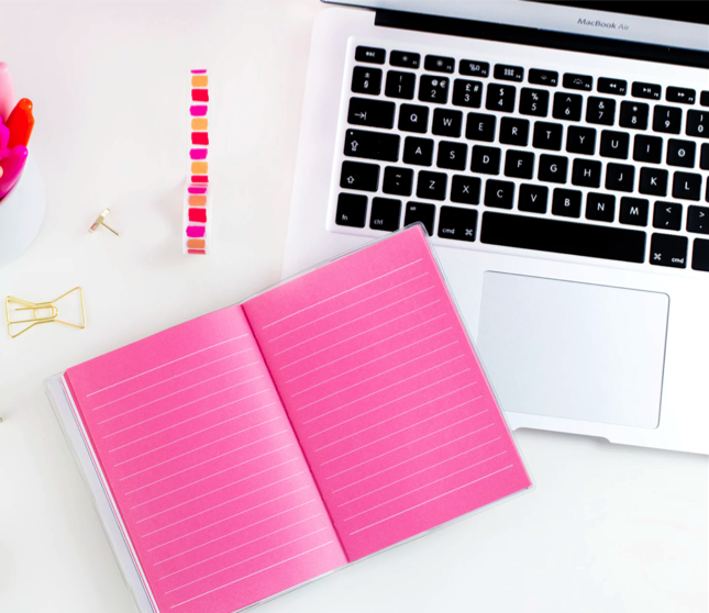 pink journal and laptop