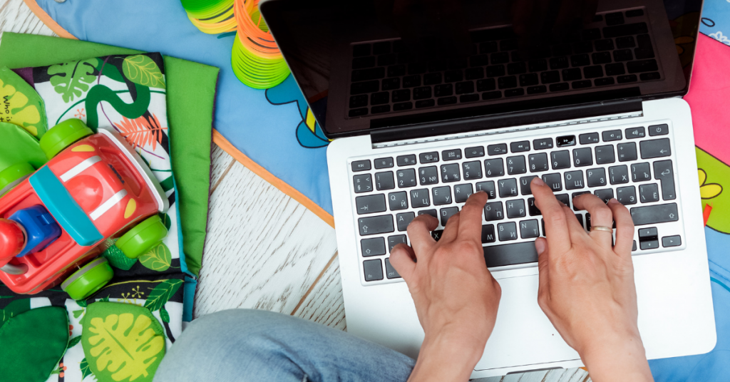 blogger typing on a laptop in a playroom